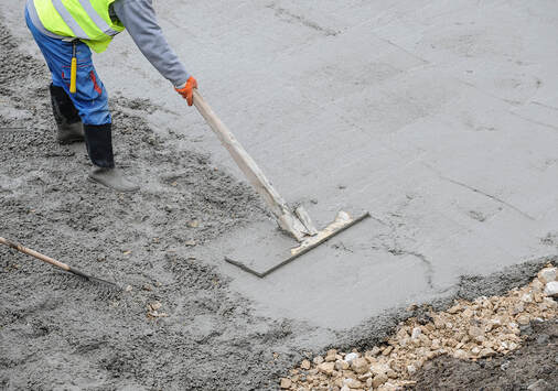 man flattening a cement